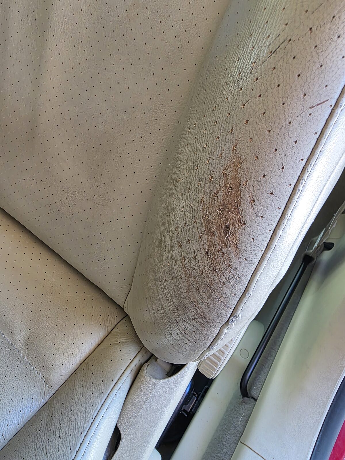 Worn leather seat armrest