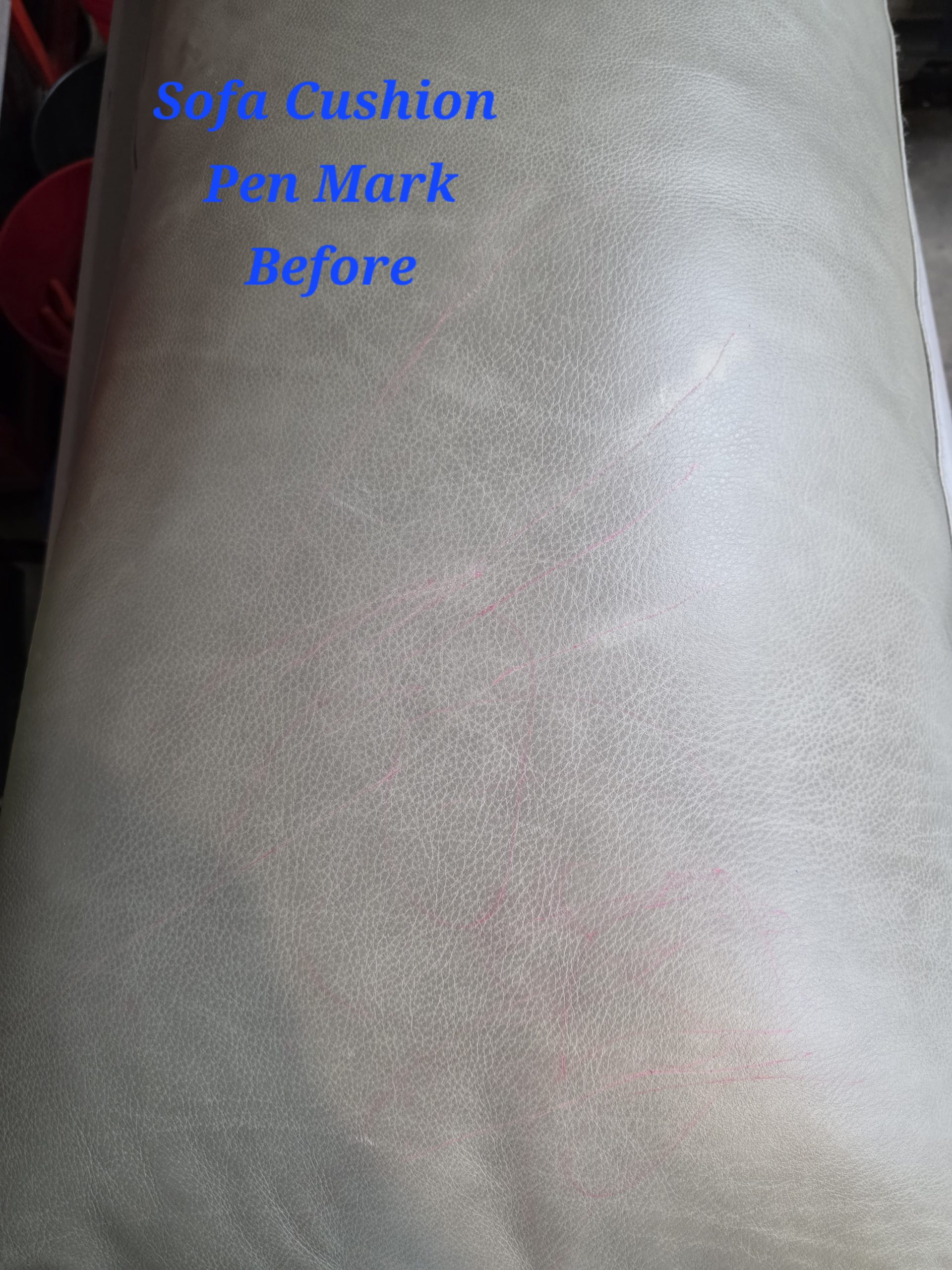 Sofa cushion with pen marks before cleaning