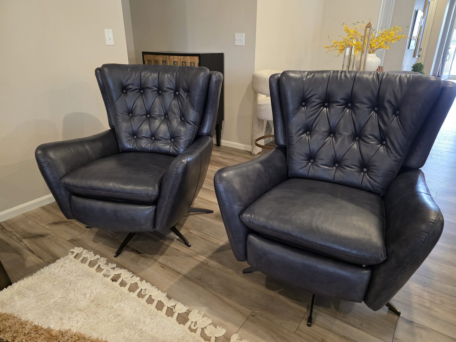 Restored black leather wingback chairs